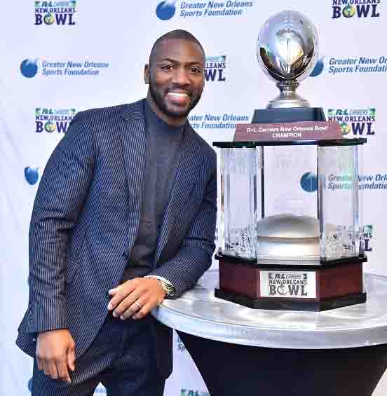 Keynote Speaker Ryan Clark poses with the championship trophy